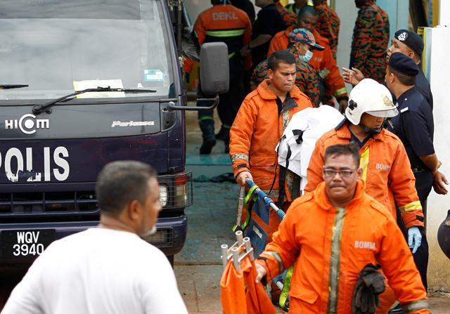 Firefighters carry a body out of religious school Darul Quran Ittifaqiyah after a fire broke out in Kuala Lumpur, Malaysia. (Reuters Photo)
