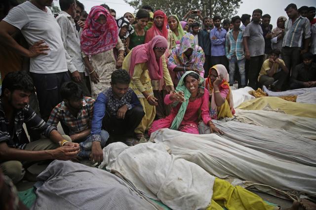 Mother of a victim wails near the dead body of her daughter as protesters block traffic by placing bodies of victims of a boat capsize on the Delhi-Saharanpur highway at Katha village. (AP Photo) Mother of a victim wails near the dead body of her daughter as protesters block traffic by placing bodies of victims of a boat capsize on the Delhi-Saharanpur highway at Katha village. (AP Photo)