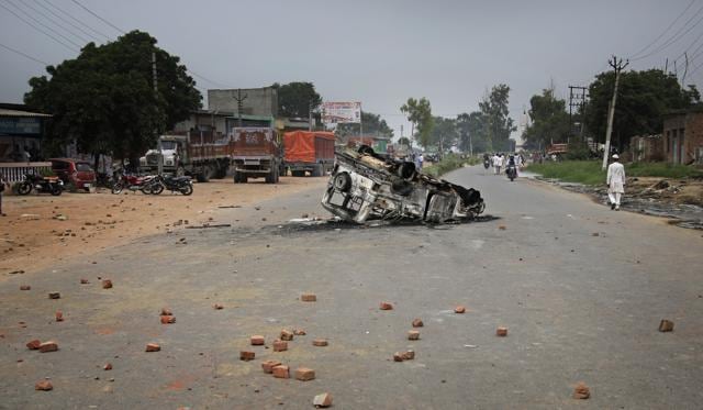 A vehicle damaged by villagers protesting after a boat capsize lies on the Delhi-Saharanpur highway at Katha village near Baghpat town. (AP Photo) A vehicle damaged by villagers protesting after a boat capsize lies on the Delhi-Saharanpur highway at Katha village near Baghpat town. (AP Photo)