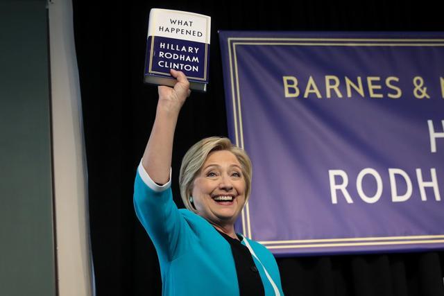 Former US Secretary of State Hillary Clinton holds up a copy of her new book What Happened at a book signing event at Barnes and Noble bookstore in New York City. (AFP) Former US Secretary of State Hillary Clinton holds up a copy of her new book What Happened at a book signing event at Barnes and Noble bookstore in New York City. (AFP)