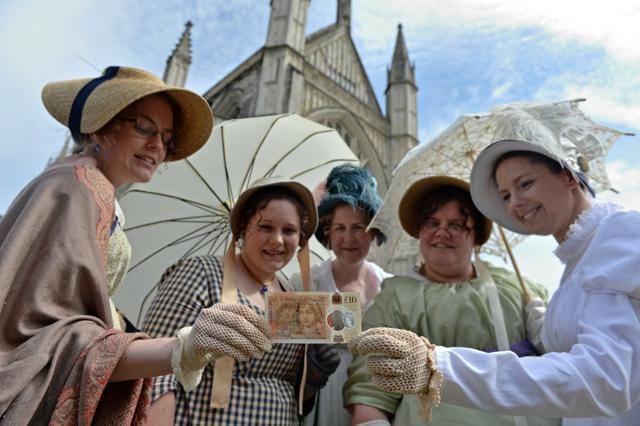 People in period costume pose with the new £10 note featuring Jane Austen, at Winchester Cathedral, in Winchester, Britain. (REUTERS)