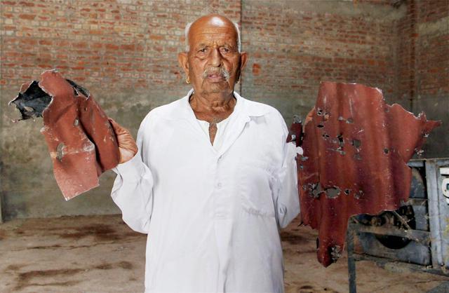 A villager shows parts of a damaged shed after firing from the Pakistan side of the border, at a village in Arnia Sector. (PTI Photo) A villager shows parts of a damaged shed after firing from the Pakistan side of the border, at a village in Arnia Sector. (PTI Photo)