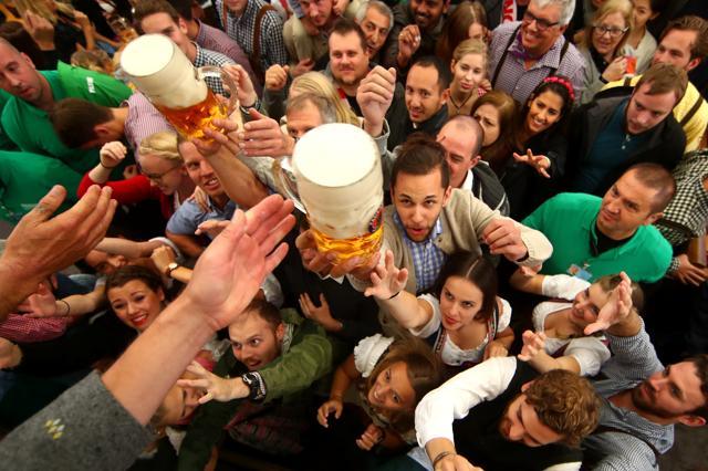Visitors reach for the first mugs of beer during the opening day of the 184th Oktoberfest. (Michael Dalder/REUTERS) Visitors reach for the first mugs of beer during the opening day of the 184th Oktoberfest. (Michael Dalder/REUTERS)