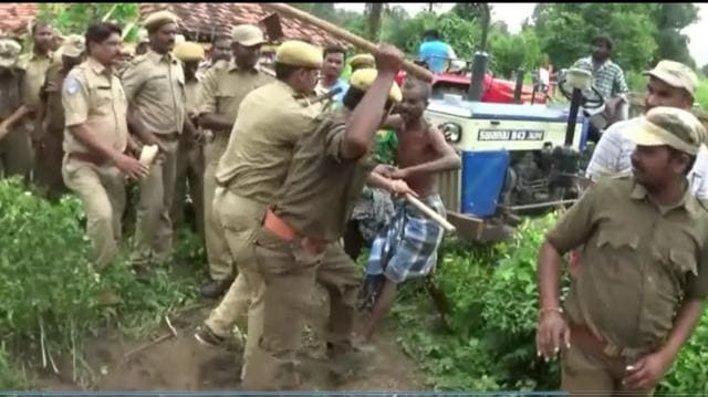 A policeman raises his lathi to restrain a tribal protester at Jalagalancha. (HT Photo) A policeman raises his lathi to restrain a tribal protester at Jalagalancha. (HT Photo)