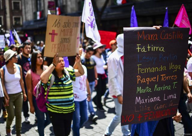 A Mexican demonstrator carries a sign with the names of recent victims of femicide or gender-motivated murders in a protest against violence against women in Mexico City. (AFP) A Mexican demonstrator carries a sign with the names of recent victims of femicide or gender-motivated murders in a protest against violence against women in Mexico City. (AFP)