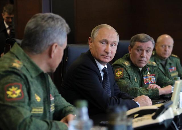 Russian President Vladimir Putin, center, speaks to Defence Minister Sergei Shoigu, left, as Chief of the General Staff of the Russian Armed Forces Valery Gerasimov, second right, looks on during a military exercise at a training ground at the Luzhsky Range, near St. Petersburg, Russia, Monday, Sept. 18, 2017. (AP) Russian President Vladimir Putin, center, speaks to Defence Minister Sergei Shoigu, left, as Chief of the General Staff of the Russian Armed Forces Valery Gerasimov, second right, looks on during a military exercise at a training ground at the Luzhsky Range, near St. Petersburg, Russia, Monday, Sept. 18, 2017. (AP)