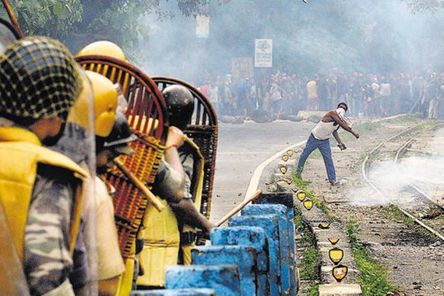 A supporter of a separate Gorkhaland state throws a projectile at police during an indefinite strike at Sukna village in Darjeeling district on the outskirts of Siliguri on July 29, 2017. (AFP) A supporter of a separate Gorkhaland state throws a projectile at police during an indefinite strike at Sukna village in Darjeeling district on the outskirts of Siliguri on July 29, 2017. (AFP)
