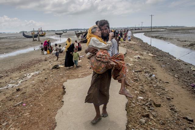 File photo of Abdul Kareem, a Rohingya Muslim man, carrying his mother, Alima Khatoon, to a refugee camp after crossing over from Myanmar into Bangladesh, at Teknaf. (AP) File photo of Abdul Kareem, a Rohingya Muslim man, carrying his mother, Alima Khatoon, to a refugee camp after crossing over from Myanmar into Bangladesh, at Teknaf. (AP)
