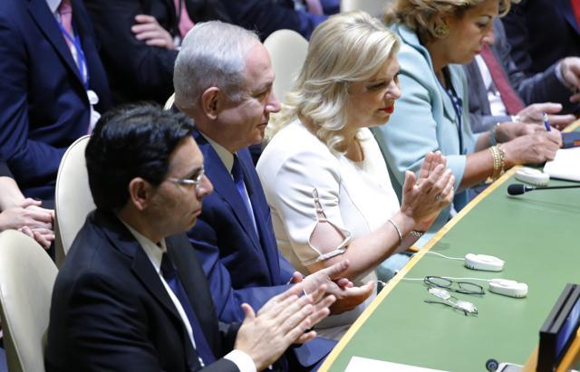 Members of the Israeli delegation, including Prime Minister Benjamin Netanyahu (C), applaud as US President Donald Trump addresses the 72nd United Nations General Assembly. (Reuters Photo)
