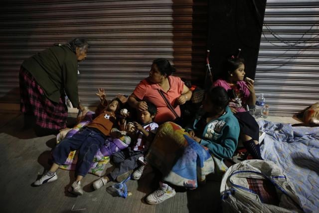Families fearing aftershocks prepare to sleep on the street in the Roma neighbourhood of Mexico City. (AP) Families fearing aftershocks prepare to sleep on the street in the Roma neighbourhood of Mexico City. (AP)