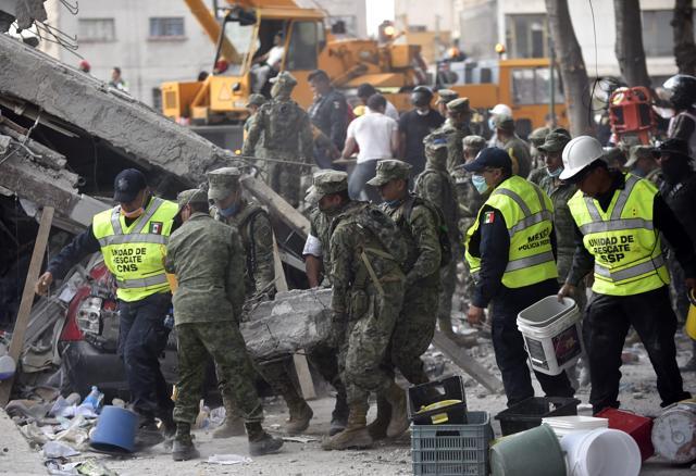 Authorities asked for help from volunteers and for water. Some police officers came through the crowd carrying containers of water. In several locations, people were seen clambering on buildings that were now piles of stone and tangled metal to pull people out. (AFP) Authorities asked for help from volunteers and for water. Some police officers came through the crowd carrying containers of water. In several locations, people were seen clambering on buildings that were now piles of stone and tangled metal to pull people out. (AFP)