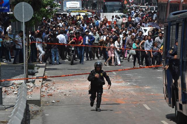 Mexican policemen run towards the site where a building collapsed after the powerful quake. “Awful. I think it was one of the strongest we’ve felt. I don’t know what magnitude, but it was awful,” said Pedro Cruz Martinez, a public servant cradling his little girl, after joining the rush of fearful parents to a local school. (AFP) Mexican policemen run towards the site where a building collapsed after the powerful quake. “Awful. I think it was one of the strongest we’ve felt. I don’t know what magnitude, but it was awful,” said Pedro Cruz Martinez, a public servant cradling his little girl, after joining the rush of fearful parents to a local school. (AFP)