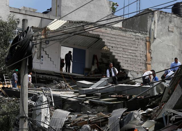 People work at a collapsed building after an earthquake in Mexico City. (REUTERS) People work at a collapsed building after an earthquake in Mexico City. (REUTERS)