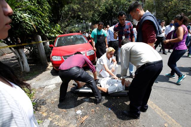 Many people lay on stretchers, medics holding strips of cardboard boxes over victims’ heads to protect them from the sun in Mexico City. Several buildings were completely flattened in Roma, popular for its bars and restaurants and one of the neighbourhoods hit hardest by the 1985 earthquake that shattered large swathes of this city and killed at least 10,000 -- 32 years ago to the day. (REUTERS) Many people lay on stretchers, medics holding strips of cardboard boxes over victims’ heads to protect them from the sun in Mexico City. Several buildings were completely flattened in Roma, popular for its bars and restaurants and one of the neighbourhoods hit hardest by the 1985 earthquake that shattered large swathes of this city and killed at least 10,000 -- 32 years ago to the day. (REUTERS)