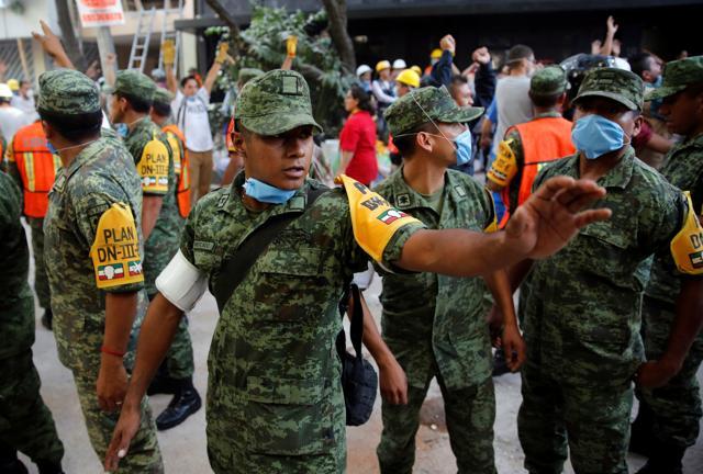 Soldiers stand guard near a collapsed building after the quake. The city’s international airport closed for more than three hours following the quake, and the stock market was forced to shut down. (REUTERS) Soldiers stand guard near a collapsed building after the quake. The city’s international airport closed for more than three hours following the quake, and the stock market was forced to shut down. (REUTERS)