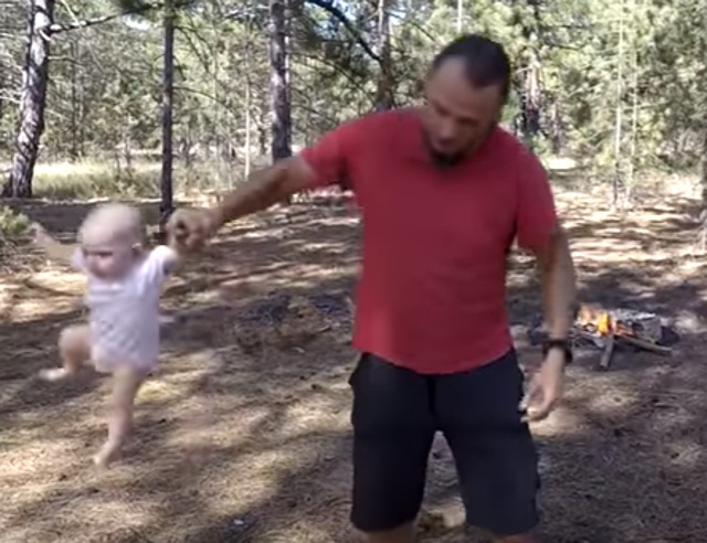 The Ukranian dad hurls his baby from side to side, throws her around by one leg. Photo credit: screengrab/Youtube