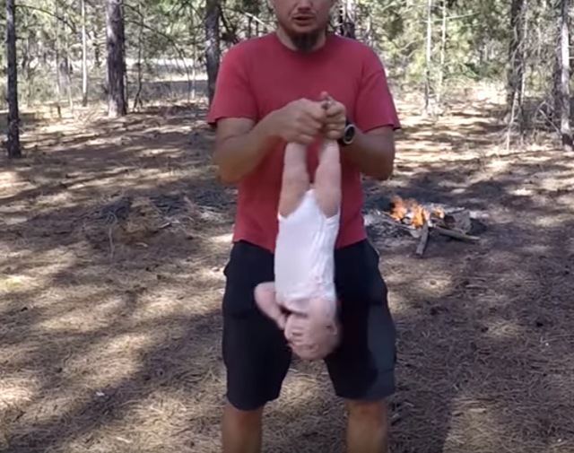 The Ukranian dad swings his daughter in the air while she squeals with fright. Photo credit: screengrab/Youtube