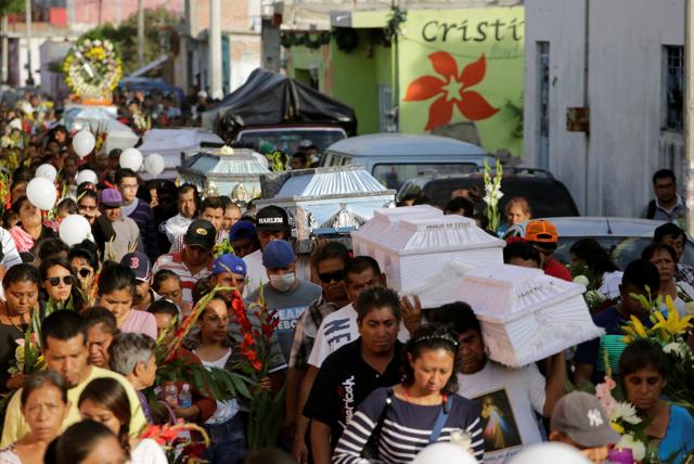 People accompany caskets holding the bodies of victims who died in the earthquake, through the streets in Atzala, on the outskirts of Puebla, Mexico on September 20, 2017. (Reuters) People accompany caskets holding the bodies of victims who died in the earthquake, through the streets in Atzala, on the outskirts of Puebla, Mexico on September 20, 2017. (Reuters)