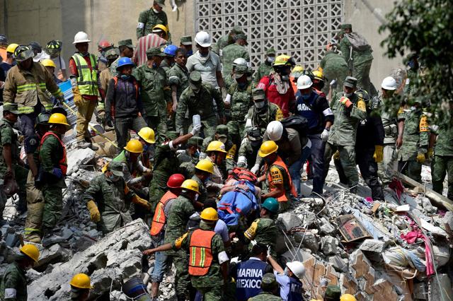 A man is pulled out of the rubble alive in Mexico City on September 20, 2017 as the search for survivors continues a day after a strong quake hit central Mexico. (AFP Photo) A man is pulled out of the rubble alive in Mexico City on September 20, 2017 as the search for survivors continues a day after a strong quake hit central Mexico. (AFP Photo)