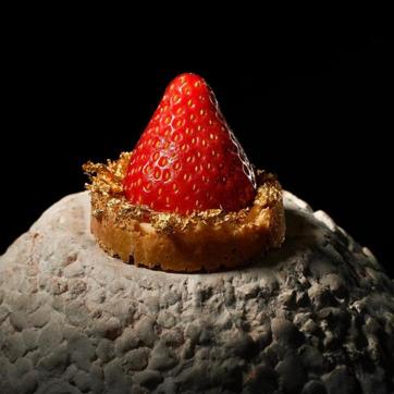 Ghewar - a Rajasthani disc-shaped sweet cake made with all-purpose flour and soaked in sugar - with elderflower cream and edible gold. (Gaggan/Facebook)