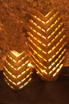An intricately carved vases with lights in terracotta. An intricately carved vases with lights in terracotta.