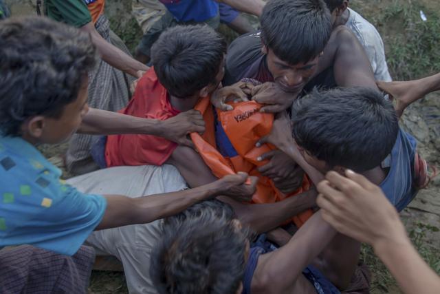 Rohingya Muslims, who crossed over from Myanmar into Bangladesh, fight for tarpaulin received in aid during its distribution near Balukhali refugee camp, Bangladesh, Monday. (AP Photo) Rohingya Muslims, who crossed over from Myanmar into Bangladesh, fight for tarpaulin received in aid during its distribution near Balukhali refugee camp, Bangladesh, Monday. (AP Photo)