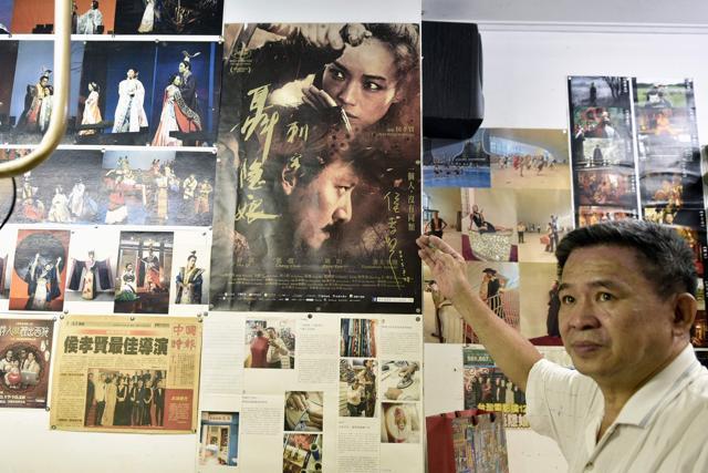 "Qipao" maker Chen Chung-hsin pointing at a movie poster for The Assassin at his studio in Taipei. Known for creating costumes for movies including Taiwanese director Hou Hsiao-hsien's Cannes-winning martial arts epic The Assassin, Chen learned his skills from his father and inherited his shop. (AFP) "Qipao" maker Chen Chung-hsin pointing at a movie poster for The Assassin at his studio in Taipei. Known for creating costumes for movies including Taiwanese director Hou Hsiao-hsien's Cannes-winning martial arts epic The Assassin, Chen learned his skills from his father and inherited his shop. (AFP)