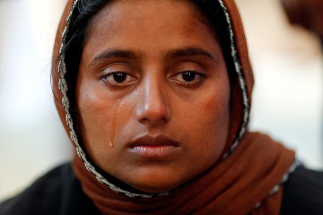 Nur Fatema, a survivor, cries over the body of her nine-month-old son who died when a boat with Rohingya refugees capsized as they were fleeing Myanmar. There was a mass funeral for the victims at Inani Beach near Cox's Bazar, Bangladesh, on September 29, 2017. (Reuters) Nur Fatema, a survivor, cries over the body of her nine-month-old son who died when a boat with Rohingya refugees capsized as they were fleeing Myanmar. There was a mass funeral for the victims at Inani Beach near Cox's Bazar, Bangladesh, on September 29, 2017. (Reuters)