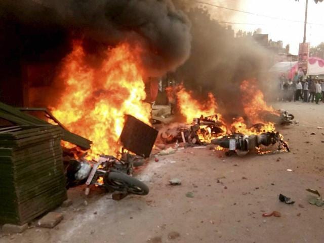 Vehicles set on fire after a clash between two communities during a Muharram procession at Param Purwa in Kanpur on Sunday. (PTI)