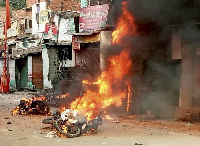 Vehicles set on fire after a clash between two communities during a Muharram procession in Kanpur on Sunday. (PTI)