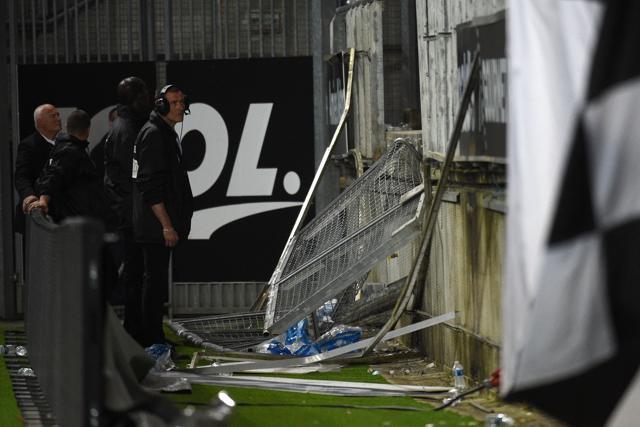 Members of the stadium staff stand by the stadium barrier that collapsed during the French L1 football match between Amiens and Lille. (AFP) Members of the stadium staff stand by the stadium barrier that collapsed during the French L1 football match between Amiens and Lille. (AFP)