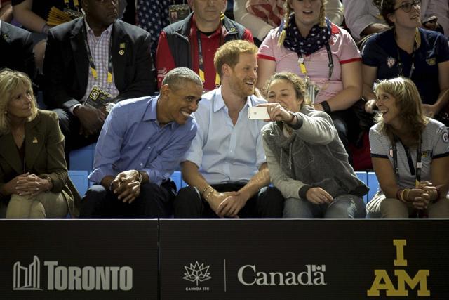 A fan takes a selfie with former US President Barack Obama as he watches wheelchair basketball with Britain's Prince Harry at the Invictus Games in Toronto. (AP Photo) A fan takes a selfie with former US President Barack Obama as he watches wheelchair basketball with Britain's Prince Harry at the Invictus Games in Toronto. (AP Photo)