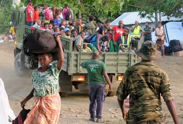 Members of the Vanuatu Mobile Force (VMF) assist residents carrying their possessions as they prepare to board a boat at Lolowai Port as they evacuate. (Reuters Photo) Members of the Vanuatu Mobile Force (VMF) assist residents carrying their possessions as they prepare to board a boat at Lolowai Port as they evacuate. (Reuters Photo)