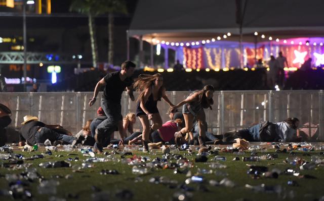 People run from the Route 91 Harvest country music festival after apparent gun fire was heard. (AFP Photo)