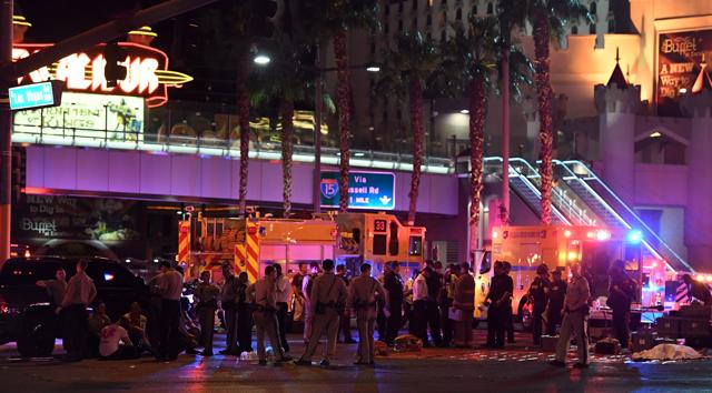 A body appears to lie under a sheet as police and rescue personnel gather at the intersection of Las Vegas Boulevard and Tropicana Ave on October 1, 2017 in Las Vegas, Nevada. (AFP) A body appears to lie under a sheet as police and rescue personnel gather at the intersection of Las Vegas Boulevard and Tropicana Ave on October 1, 2017 in Las Vegas, Nevada. (AFP)