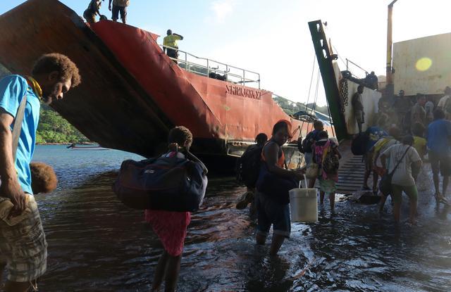 Residents carry possessions as they board a boat at Lolowai Port. (Reuters Photo) Residents carry possessions as they board a boat at Lolowai Port. (Reuters Photo)