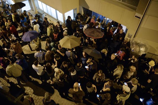 People gather outside a polling station waiting for poll results on October 1, 2017 in Barcelona. (AFP)
