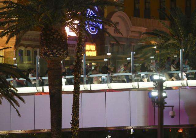 People run from the New York New York during an active shooter situation on the Las Vegas Strip in Las Vegas. (AP Photo)