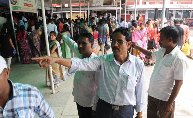 Three accused persons released by the Jharkhand high court on bail help visitors to RIMS negotiate their way through the hospital out-patient department as part of their community service obligations on Tuesday. (Diwakar Prasad/ HT Photo)