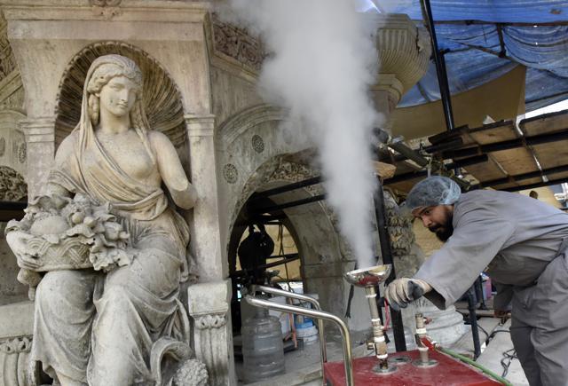 A team member gives finishing touches to one of the four life-size female mythological figures in the sculpture. While the British used special limestone to build the monument, it was tarnished over the years owing to the patch work and weather. (Kunal Patil/HT Photo) A team member gives finishing touches to one of the four life-size female mythological figures in the sculpture. While the British used special limestone to build the monument, it was tarnished over the years owing to the patch work and weather. (Kunal Patil/HT Photo)