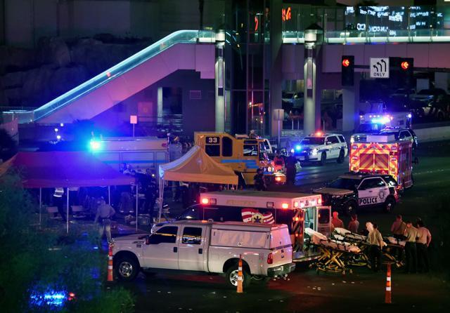 Police and rescue personnel gather at the intersection of Las Vegas Boulevard and Tropicana Avenue. after a mass shooting at a country music festival nearby. (AFP Photo) Police and rescue personnel gather at the intersection of Las Vegas Boulevard and Tropicana Avenue. after a mass shooting at a country music festival nearby. (AFP Photo)