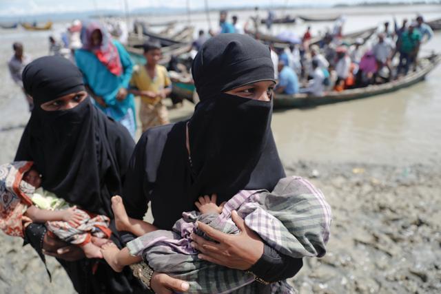 Rohingya refugees who just arrived from Myanmar carry their newborn babies as they make their way to a relief centre in Teknaf, near Cox's Bazar, in Bangladesh on October 3, 2017. (Reuters) Rohingya refugees who just arrived from Myanmar carry their newborn babies as they make their way to a relief centre in Teknaf, near Cox's Bazar, in Bangladesh on October 3, 2017. (Reuters)