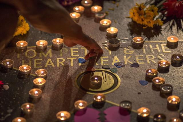 A man touches the Tom Petty and the Heartbreakers star on The Hollywood Walk of Fame after Petty suffered a massive heart attack on Monday. (AFP) A man touches the Tom Petty and the Heartbreakers star on The Hollywood Walk of Fame after Petty suffered a massive heart attack on Monday. (AFP)