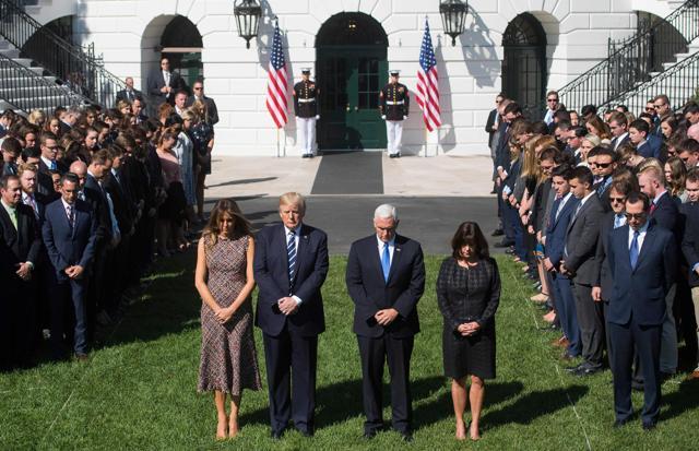 US President Donald Trump First Lady Melania Trump, US vice-president Mike Pence and his wife Karen participate in a moment of silence on the South Lawn of the White House in Washington, DC. (AFP Photo)