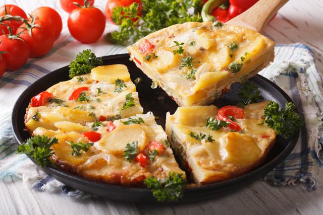 Spanish omelets, with everything from ham to potatoes and chillis, can be sliced like a pie or a pizza (Shutterstock)