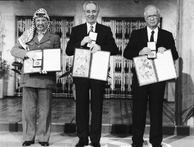 PLO leader Yasser Arafat (left) Israeli Prime Minister Yitzhak Rabin (centre) and Israeli foreign minister Shimon Peres pose with their medals and diplomas, after receiving the 1994 Nobel Peace Prize in Oslo's City Hall. (AP File Photo) PLO leader Yasser Arafat (left) Israeli Prime Minister Yitzhak Rabin (centre) and Israeli foreign minister Shimon Peres pose with their medals and diplomas, after receiving the 1994 Nobel Peace Prize in Oslo's City Hall. (AP File Photo)