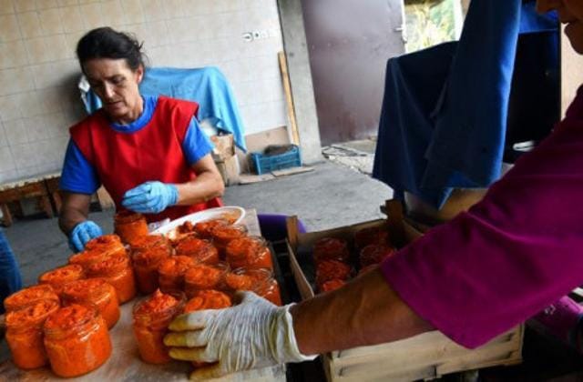 Bosnian women pack freshly cooked ajvar into glass jars. (AFP) Bosnian women pack freshly cooked ajvar into glass jars. (AFP)