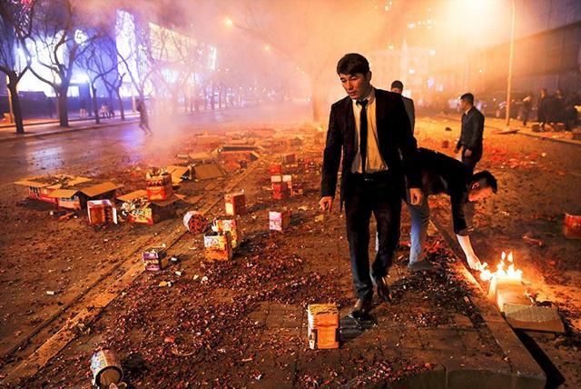 People make sure that all firecrackers have exploded during celebrations for the start of the Chinese New Year just before midnight in Beijing in February 2016. (Reuters) People make sure that all firecrackers have exploded during celebrations for the start of the Chinese New Year just before midnight in Beijing in February 2016. (Reuters)