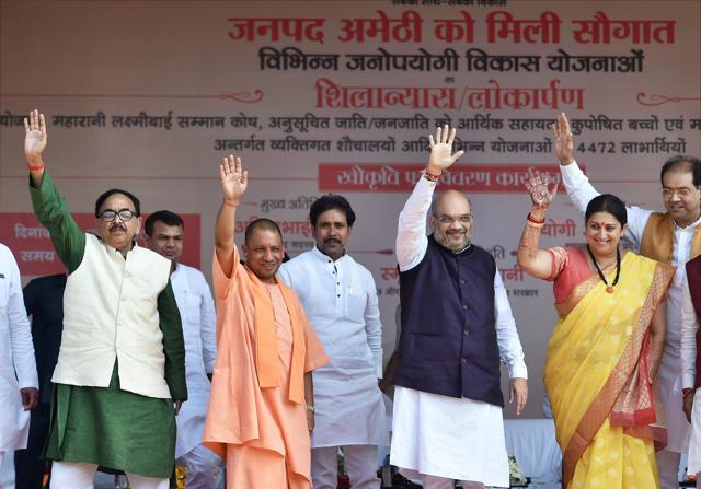 BJP national president Amit Shah with Union I & B minister Smriti Irani, UP chief minister Yogi and UP BJP chief Mahendra Nath Pandey during a public meeting for the launch of several development schemes in Gauriganj, Amethi on Tuesday. (PTI Photo) BJP national president Amit Shah with Union I & B minister Smriti Irani, UP chief minister Yogi and UP BJP chief Mahendra Nath Pandey during a public meeting for the launch of several development schemes in Gauriganj, Amethi on Tuesday. (PTI Photo)