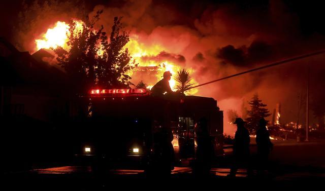 Gold Fidge firefighters use a deck gun to protect structures in Coffey Park in Santa Rosa, Calif., Monday Oct. 9, 2017. (AP) Gold Fidge firefighters use a deck gun to protect structures in Coffey Park in Santa Rosa, Calif., Monday Oct. 9, 2017. (AP)